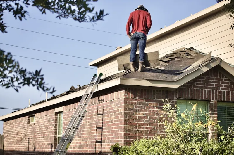 Professional roofer working on a residential roof in The Oaks